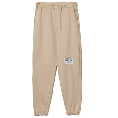 Comme Des Fuckdown Chic Beige Träningsbyxor i bomull med slitna detaljer